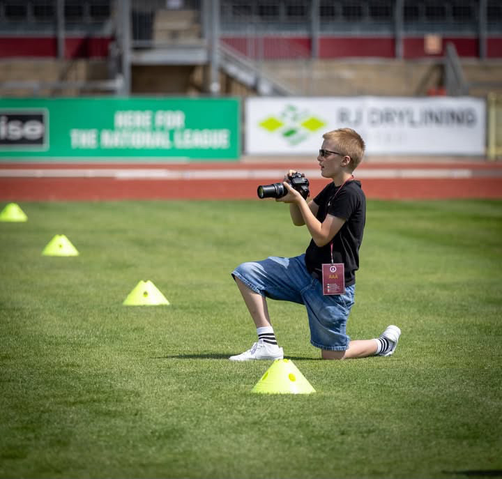Louie Harrington photographing from the sideline