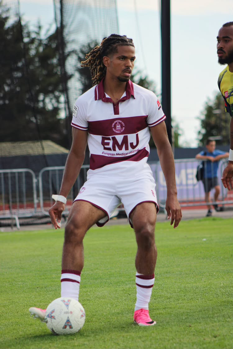 Football player focused over the ball before play